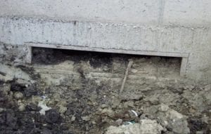 Picture of a small, debris-crusted pit fan transition
